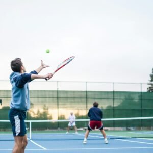 four men playing double tennis during daytime